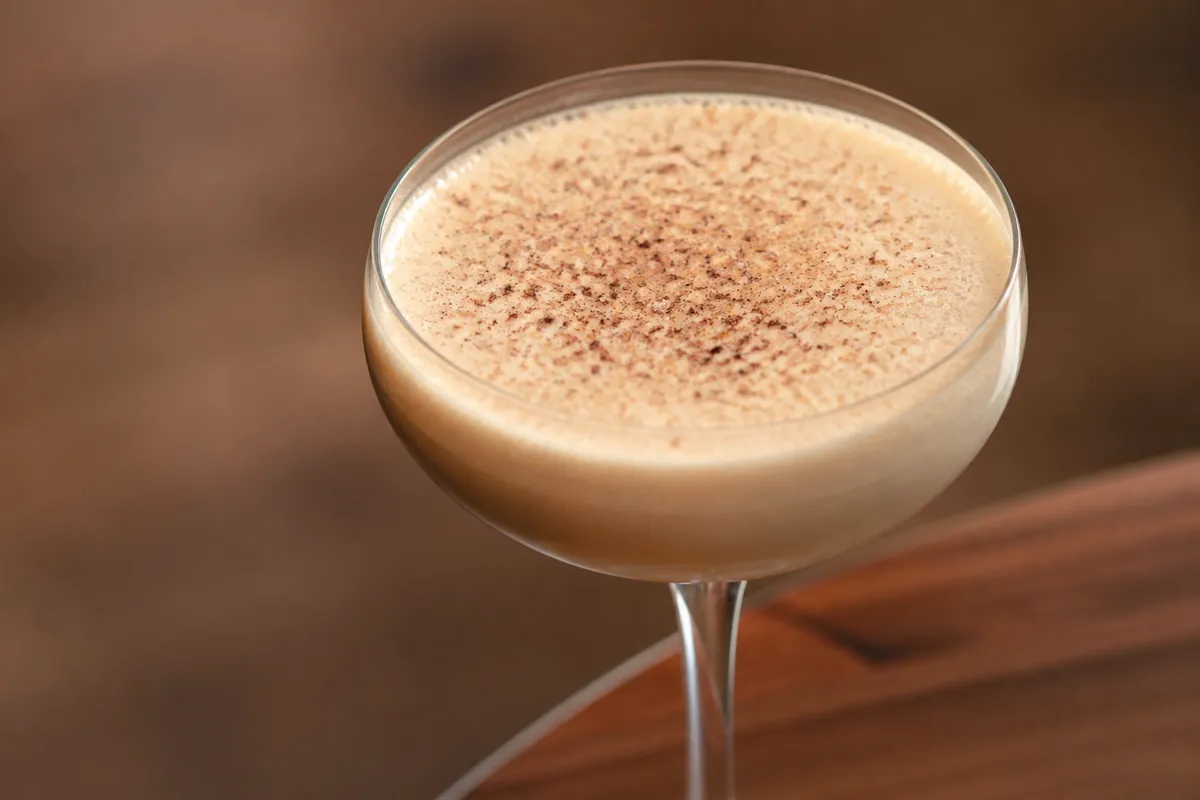 Brandy Flip in a coupe, pale tan foam, nutmeg dust, ungarnished otherwise.