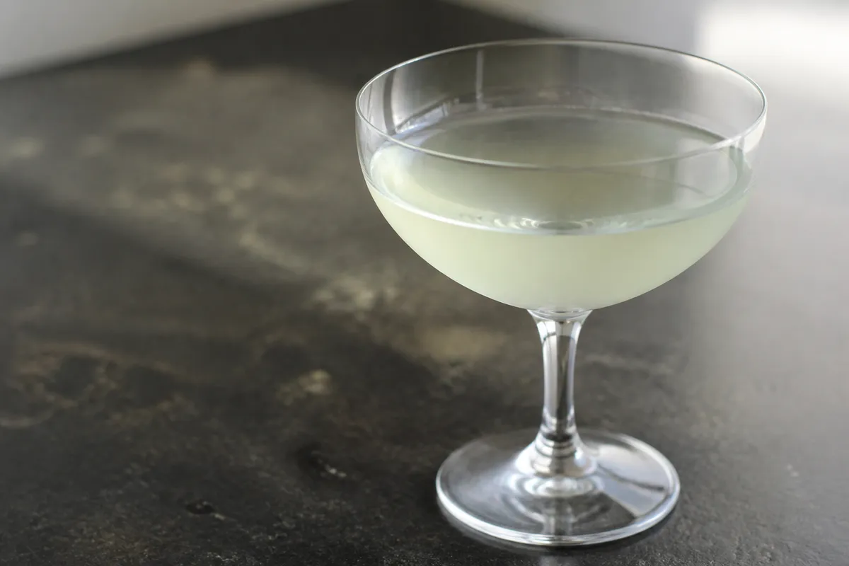 Mezcal Last Word in a coupe, pale green, ungarnished.