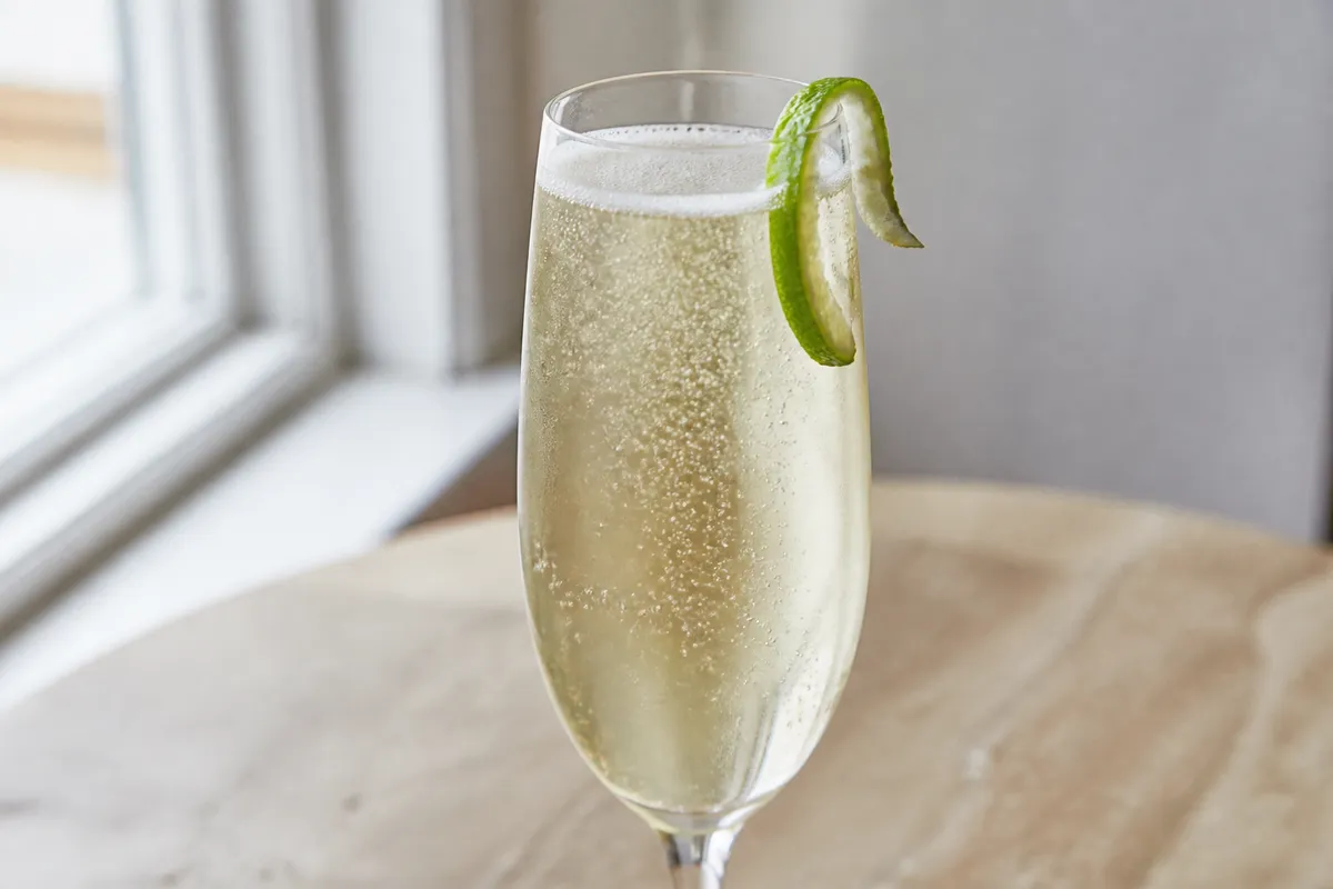 An Air Mail in a flute with a postage stamp garnish (optional) or lime twist.