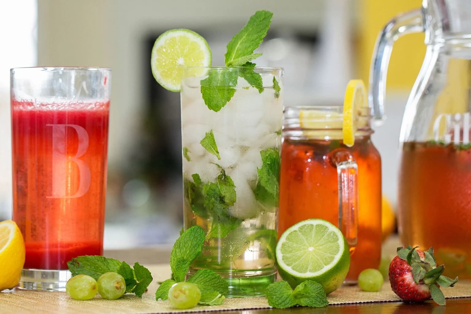 Several guest cocktails and a pitcher on a bright kitchen table
