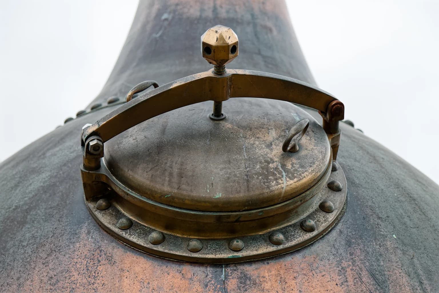 Brass manway on Gilbey’s copper gin still at Harlow Museum — where the botanical bill is locked in