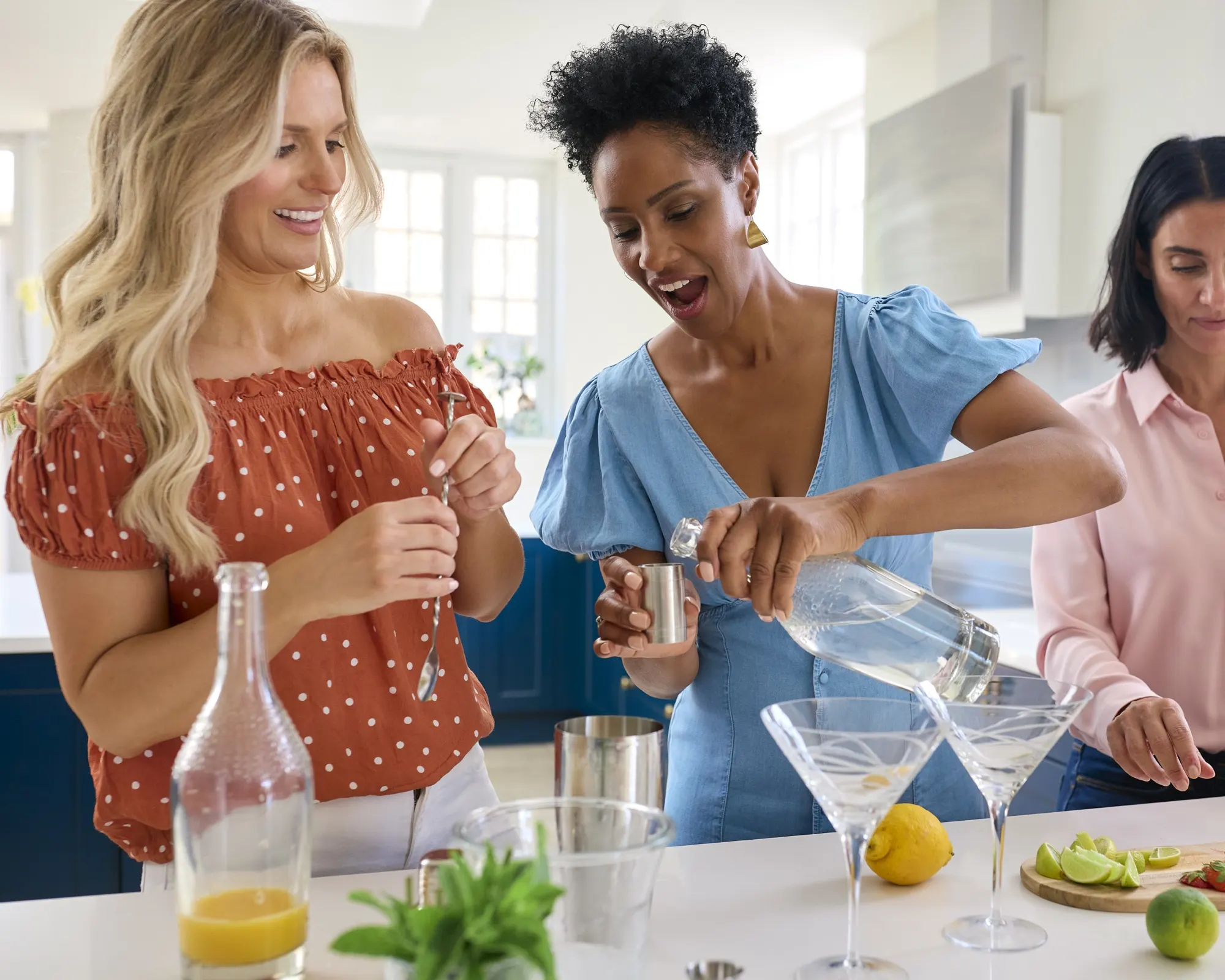 Friends gathered around cocktails at a home table