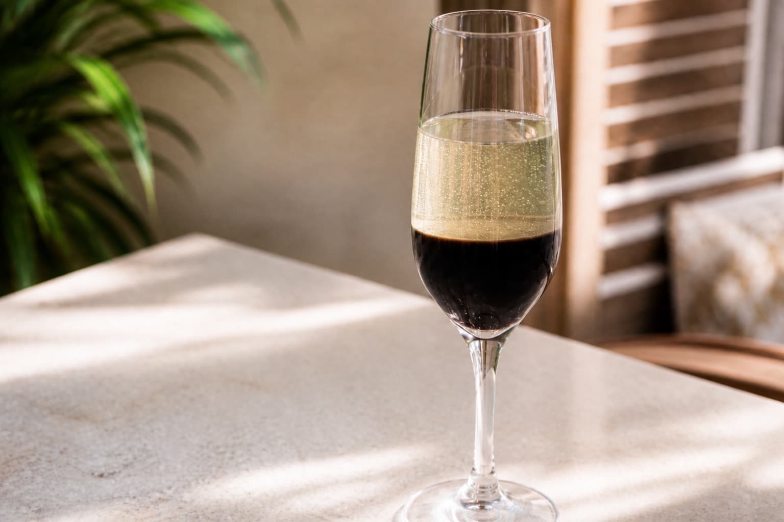 A tall flute of French 75 with fine bubbles and a long lemon twist.