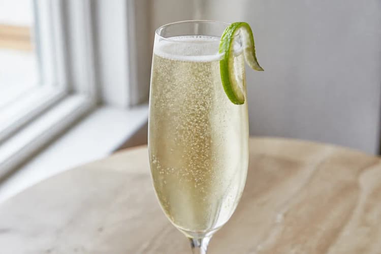 An Air Mail in a flute with a postage stamp garnish (optional) or lime twist.