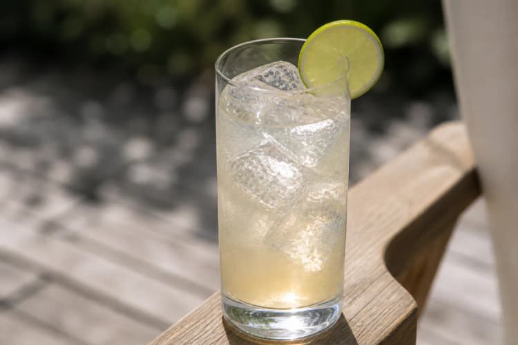 Chilcano in a highball over ice, pale gold ginger, lime wheel and optional bitters stain.
