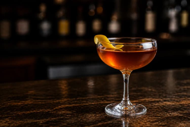 Corpse Reviver No. 1 in a coupe, deep amber, optional orange twist.