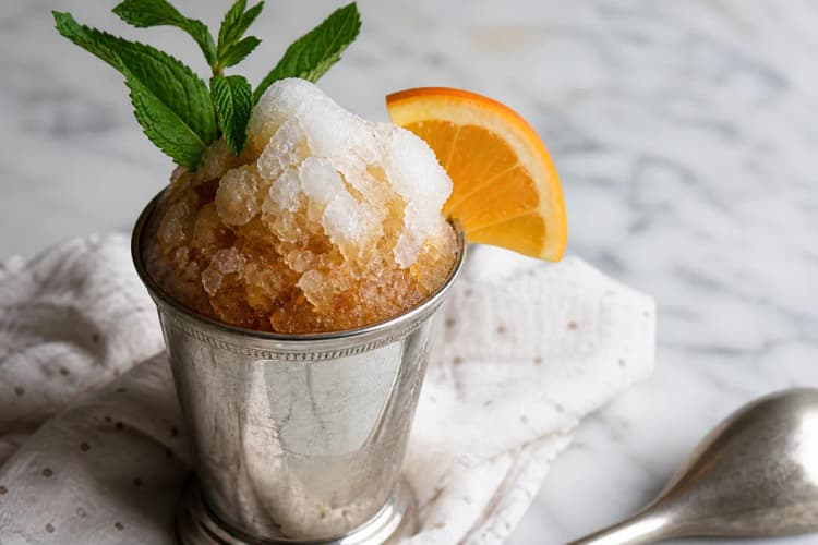 A Sherry Cobbler in a metal cup or goblet piled high with crushed ice and fruit.