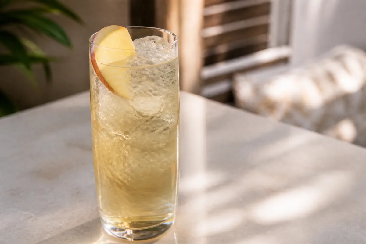 Stone Fence in a highball over ice, pale gold, apple slice optional.