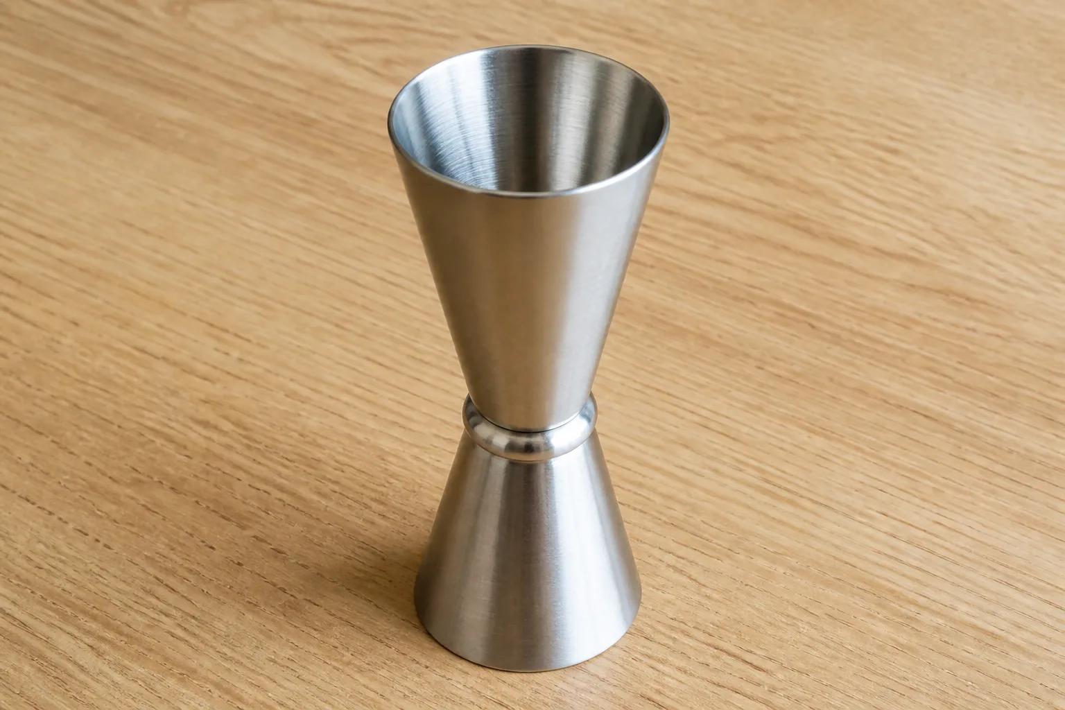 Stainless steel double jigger on a kitchen counter