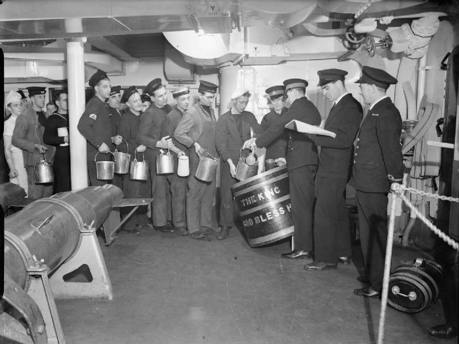 Royal Navy sailors lining up for the daily rum ration aboard HMS King George V in 1940