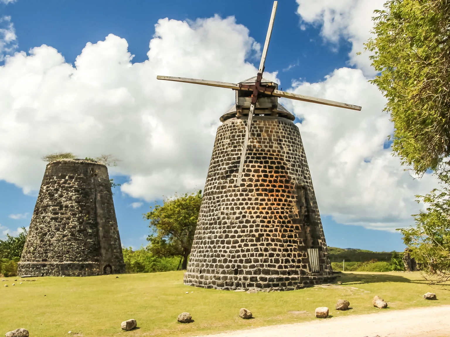 Stone sugar-mill windmills at Betty's Hope plantation in Antigua, one still carrying sail arms